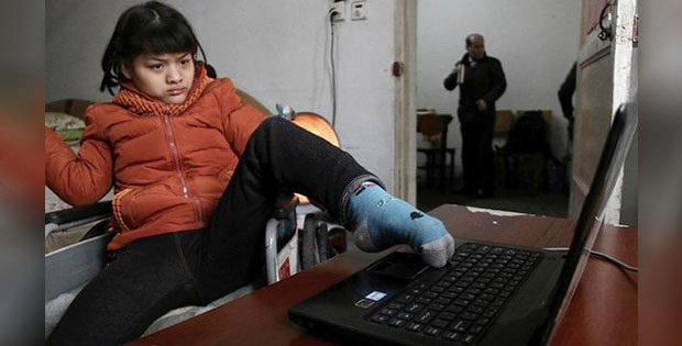 21-year-old Hu Huinyuan suffering from serious cerebral disorder is writing a fiction novel by typing with her left foot's toes.